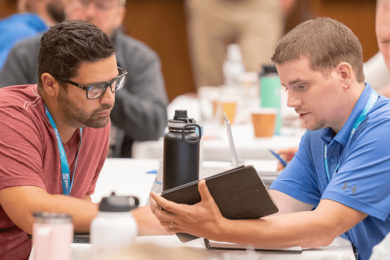 two people looking at an ipad